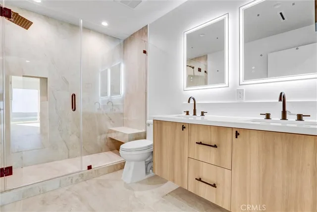 a bathroom with a double vanity sink toilet and shower