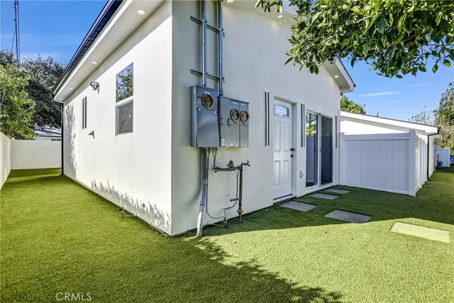 a view of a small space with wooden floor and a window