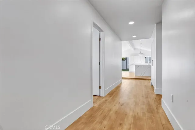 a view of a hallway with wooden floor