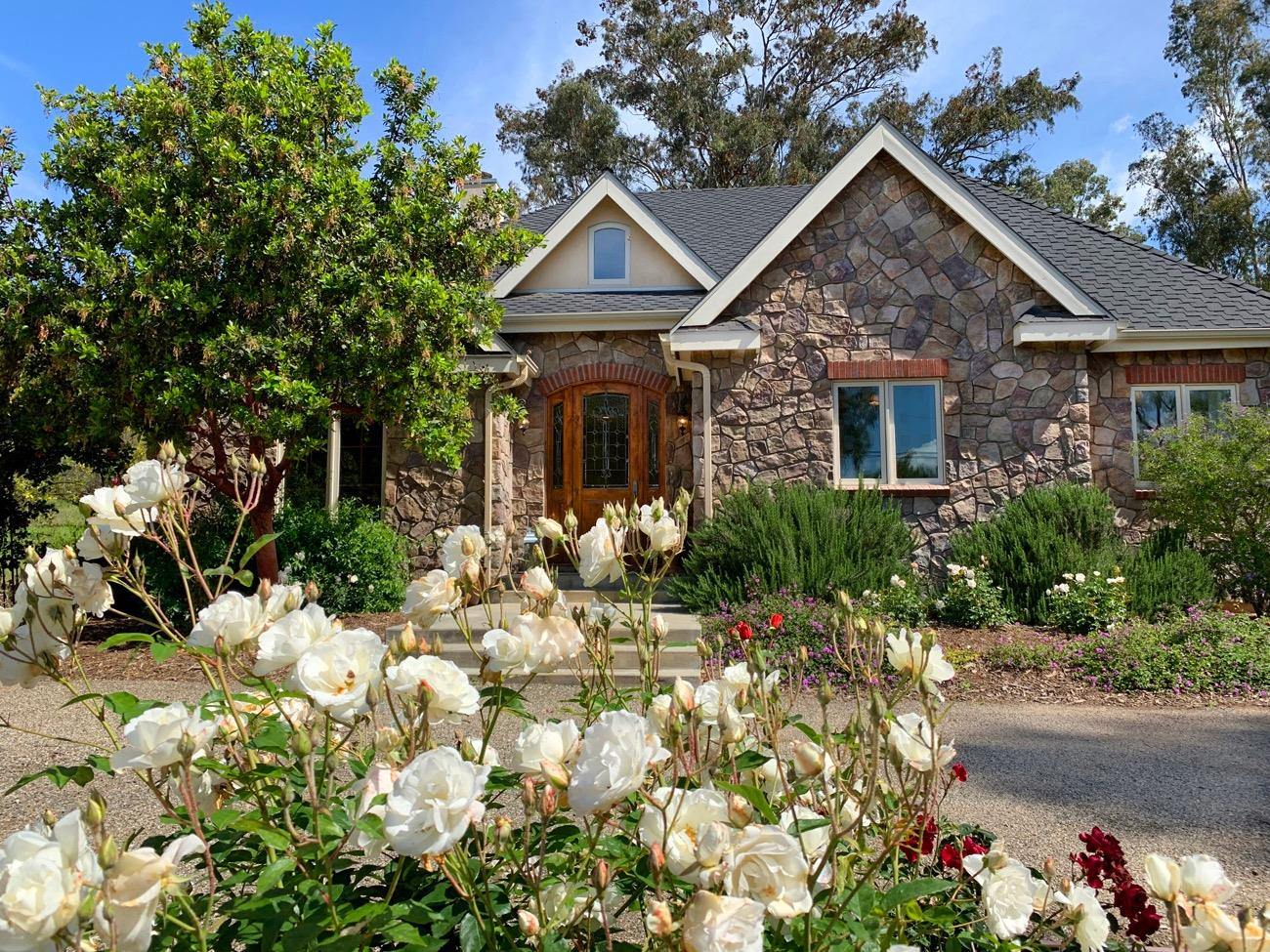 1010 El Toro Road Ojai, CA 93023 - Photo 12 of 49 a front view of a house with a yard and a garden
