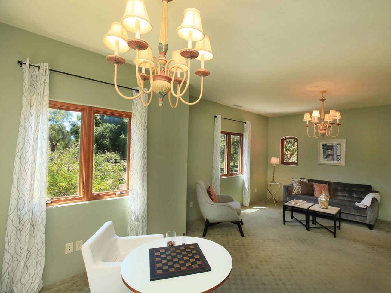 1010 El Toro Road Ojai, CA 93023 - Photo 23 of 49 a living room with furniture a table and a chandelier