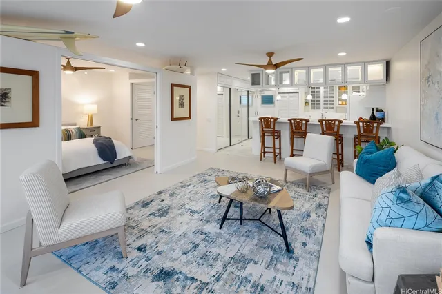 a living room with furniture and kitchen view