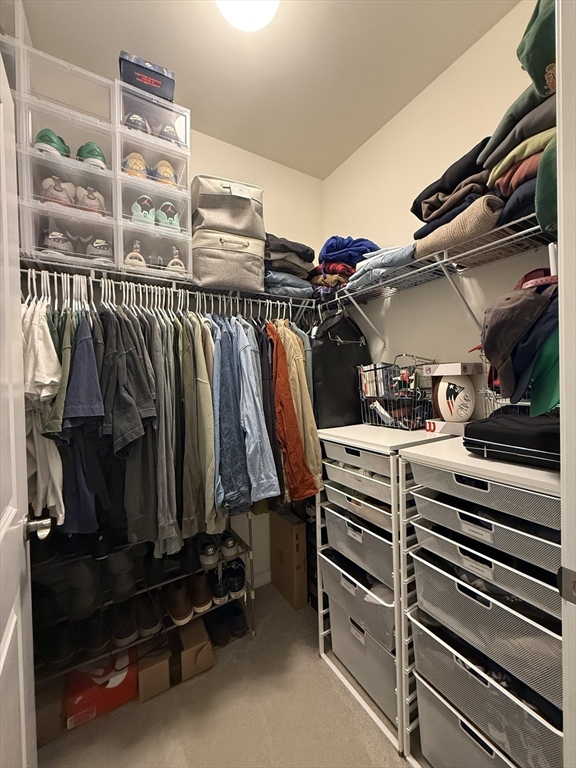 70 Trotter Road, Unit 310 Weymouth, MA 02190 - Photo 8 of 14 a view of walk in closet with clothes and shoes