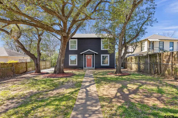 a house that has a tree in front of it