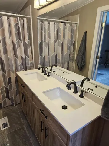 a bathroom with a double vanity sink and a mirror