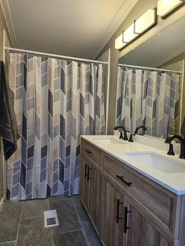 a bathroom with a double vanity sink and a mirror