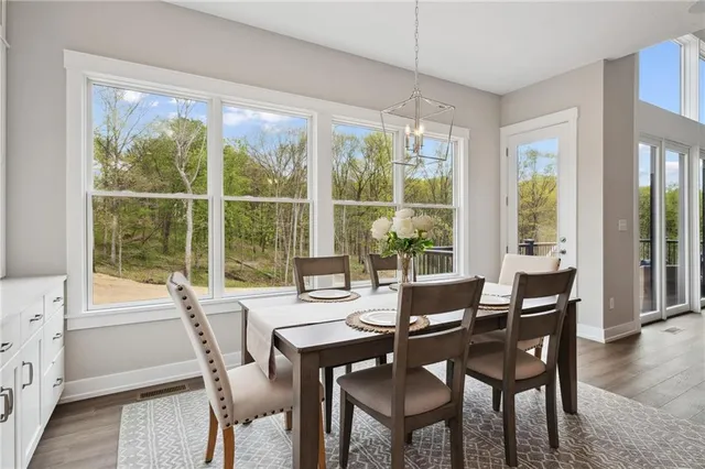 a view of a hallway with wooden floor and furniture