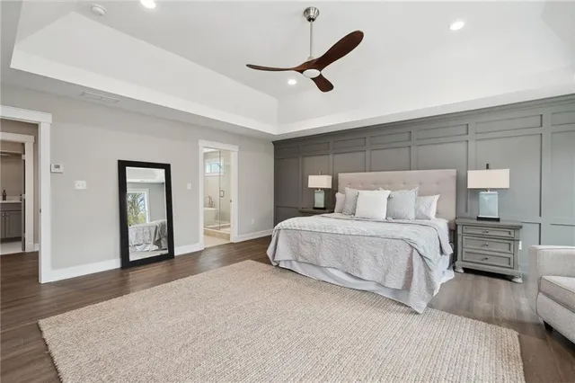 a spacious bathroom with a double vanity sink a large mirror and a bathtub