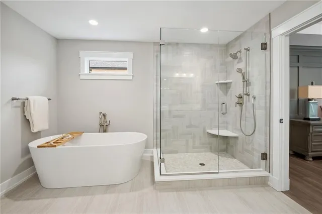 a living room with fireplace furniture and a large window