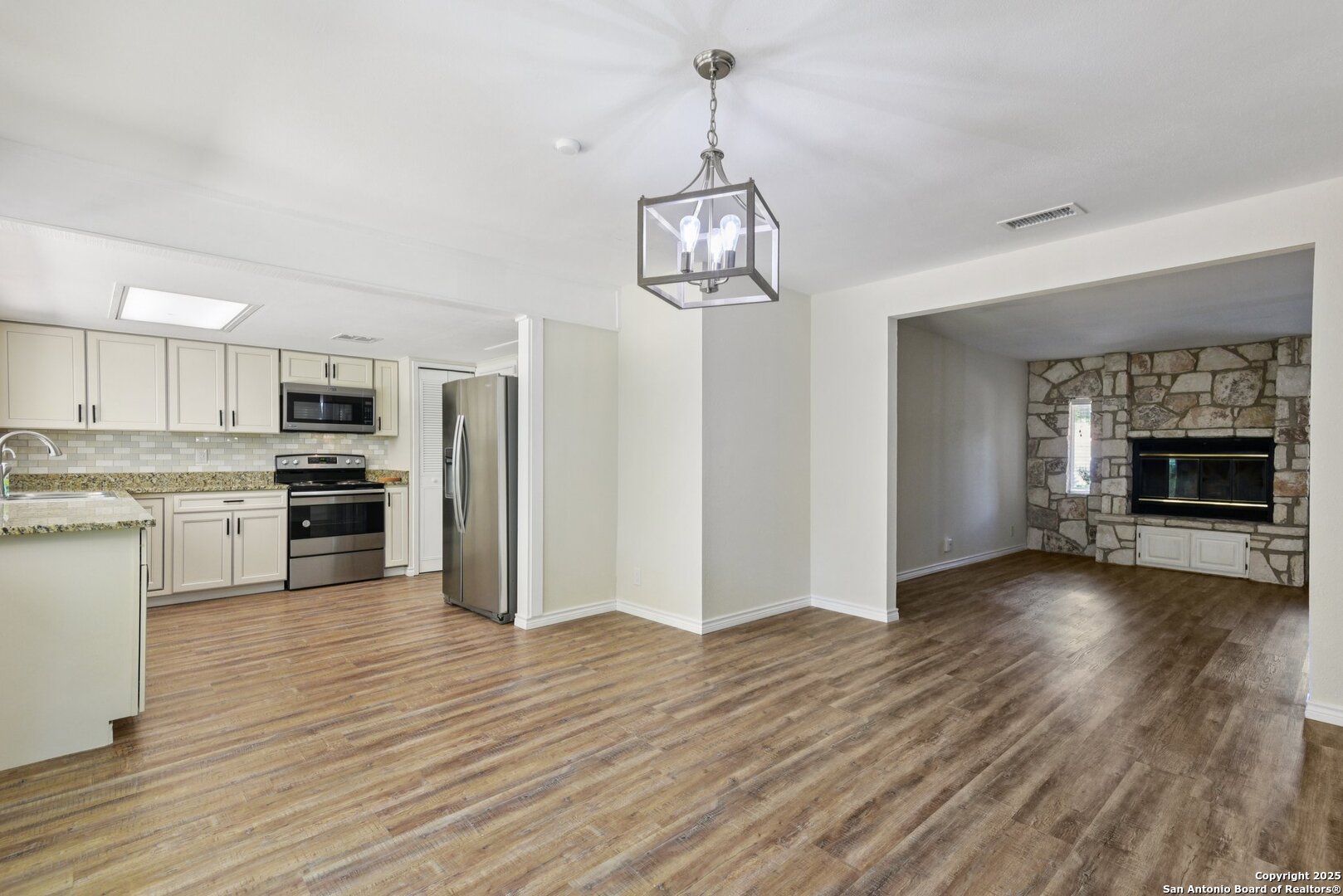 6630 Spring Hollow Street San Antonio, TX 78249 - Photo 11 of 40 a view of a kitchen with a sink cabinets and wooden floor