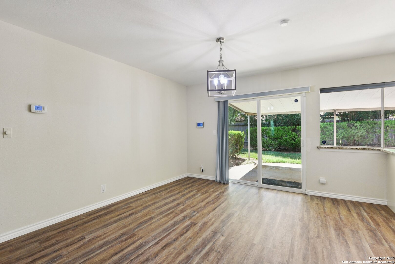 6630 Spring Hollow Street San Antonio, TX 78249 - Photo 13 of 40 a view of empty room with wooden floor and fan