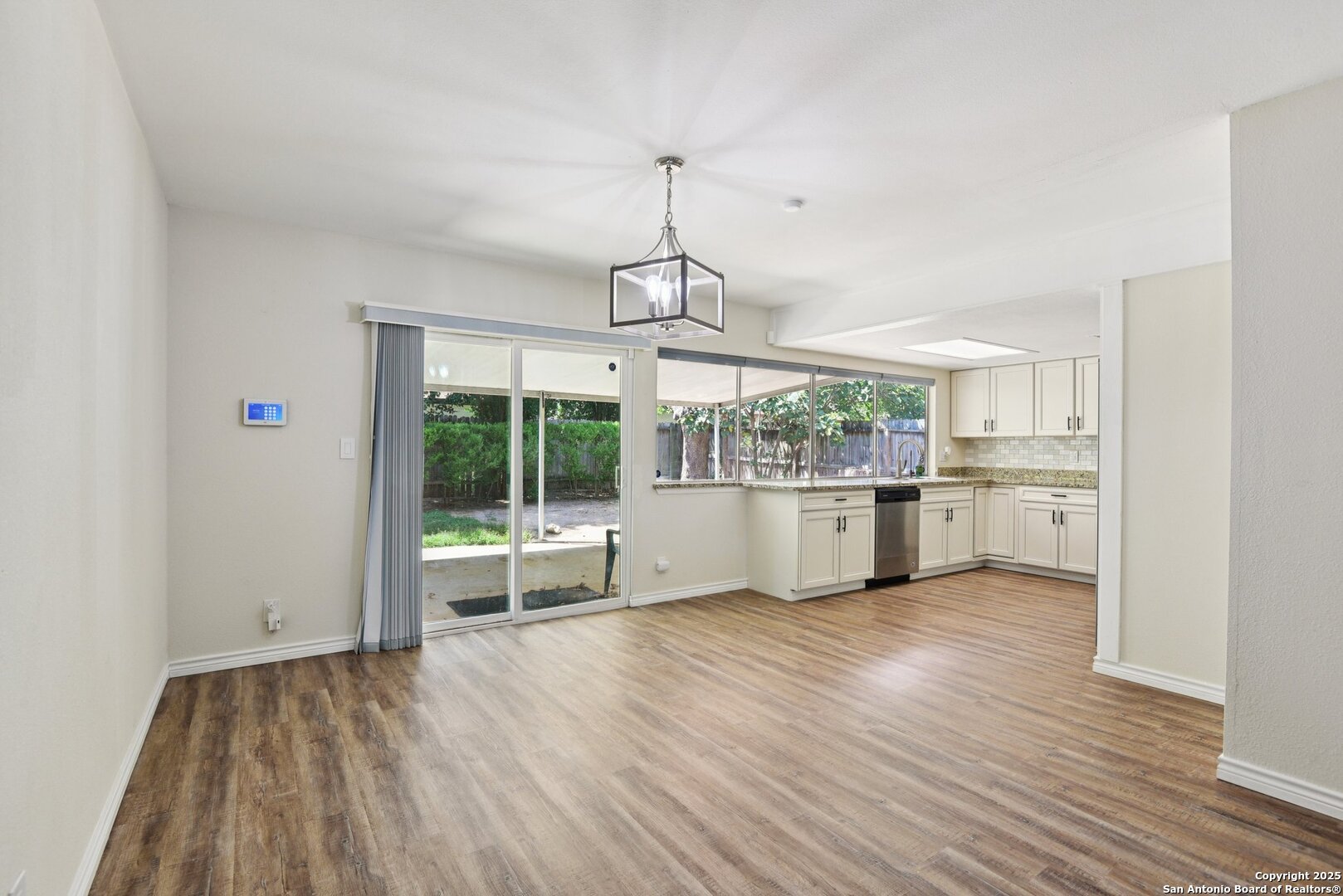 6630 Spring Hollow Street San Antonio, TX 78249 - Photo 14 of 40 a view of a kitchen with wooden floor and windows