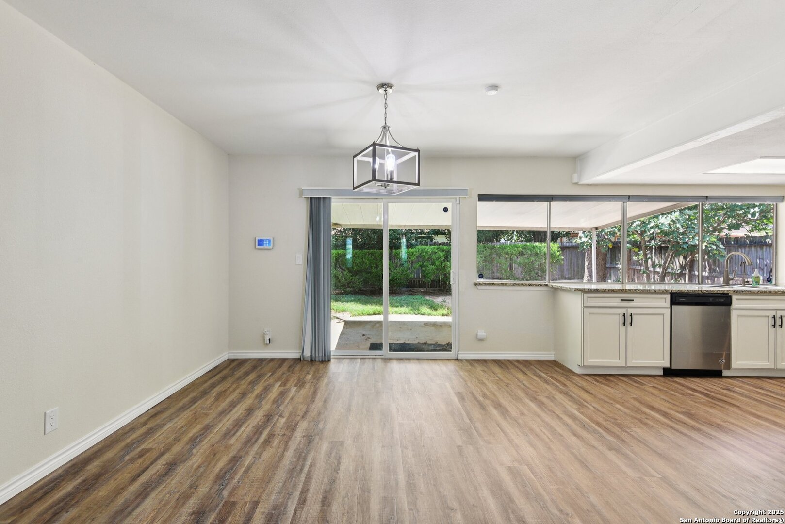 6630 Spring Hollow Street San Antonio, TX 78249 - Photo 15 of 40 a view of empty room with wooden floor and outdoor view
