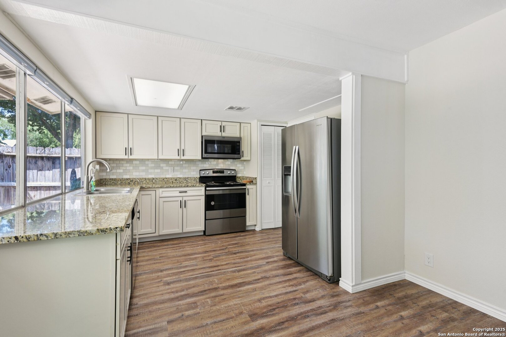 6630 Spring Hollow Street San Antonio, TX 78249 - Photo 16 of 40 a kitchen with granite countertop a refrigerator stove and sink
