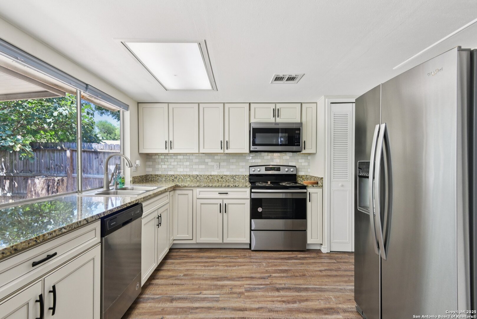 6630 Spring Hollow Street San Antonio, TX 78249 - Photo 18 of 40 a kitchen with stainless steel appliances granite countertop a refrigerator and a sink