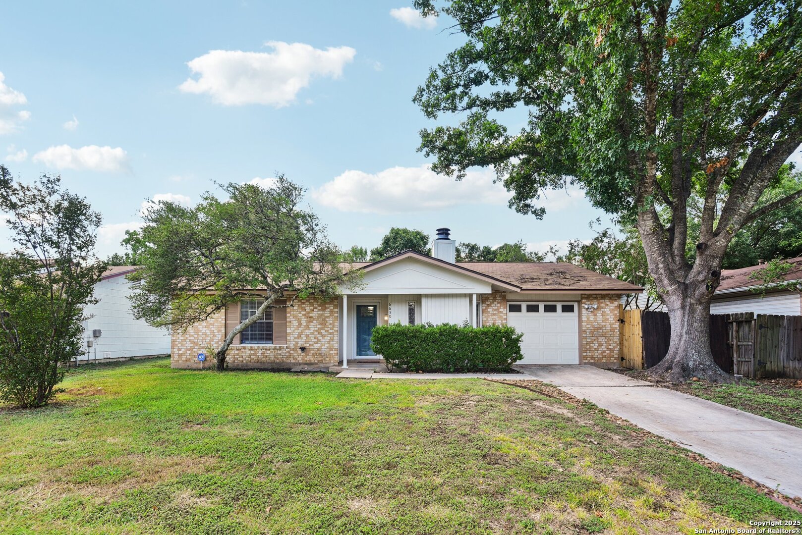 6630 Spring Hollow Street San Antonio, TX 78249 - Photo 2 of 40 a front view of a house with garden