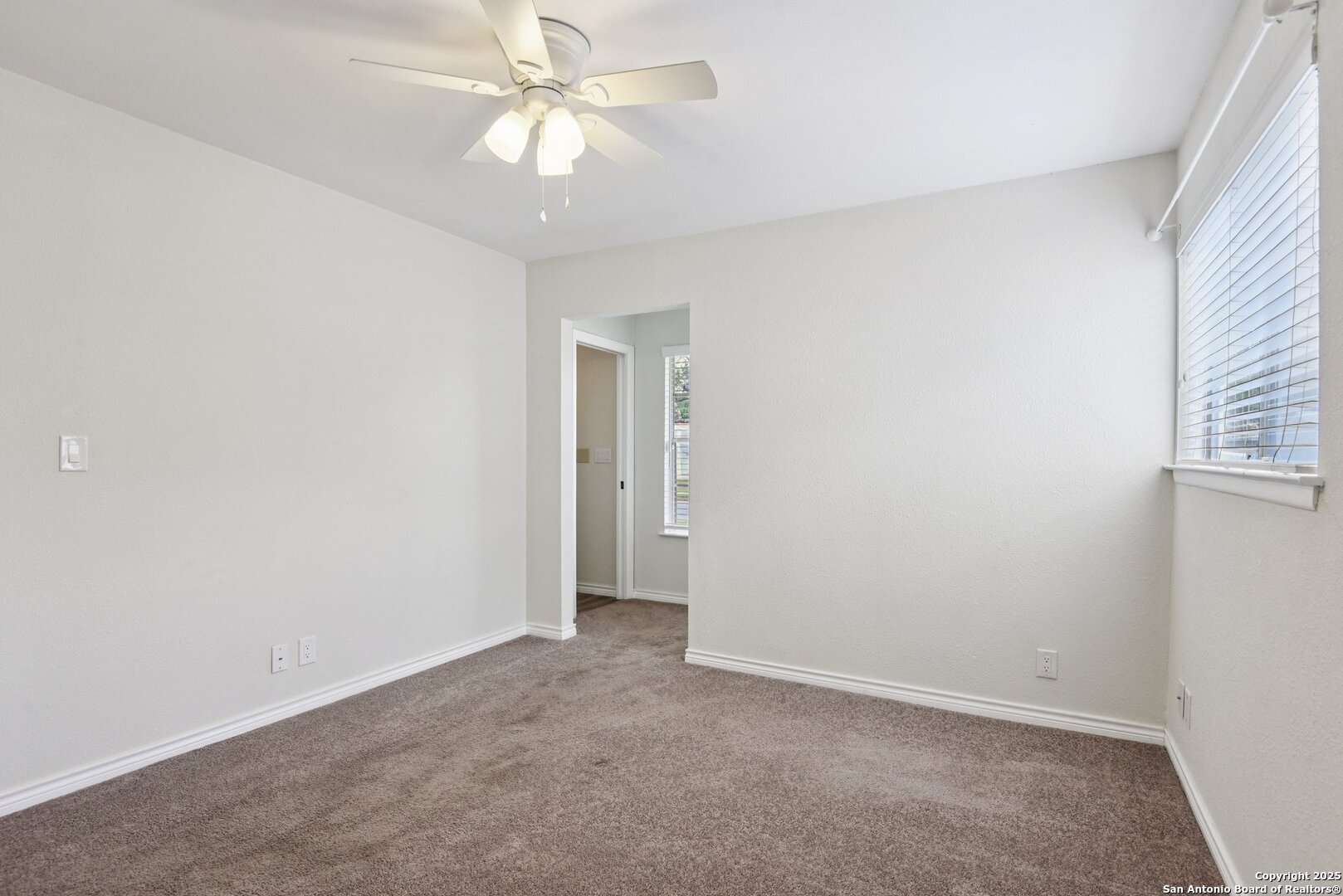 6630 Spring Hollow Street San Antonio, TX 78249 - Photo 29 of 40 an empty room with a ceiling fan and a window