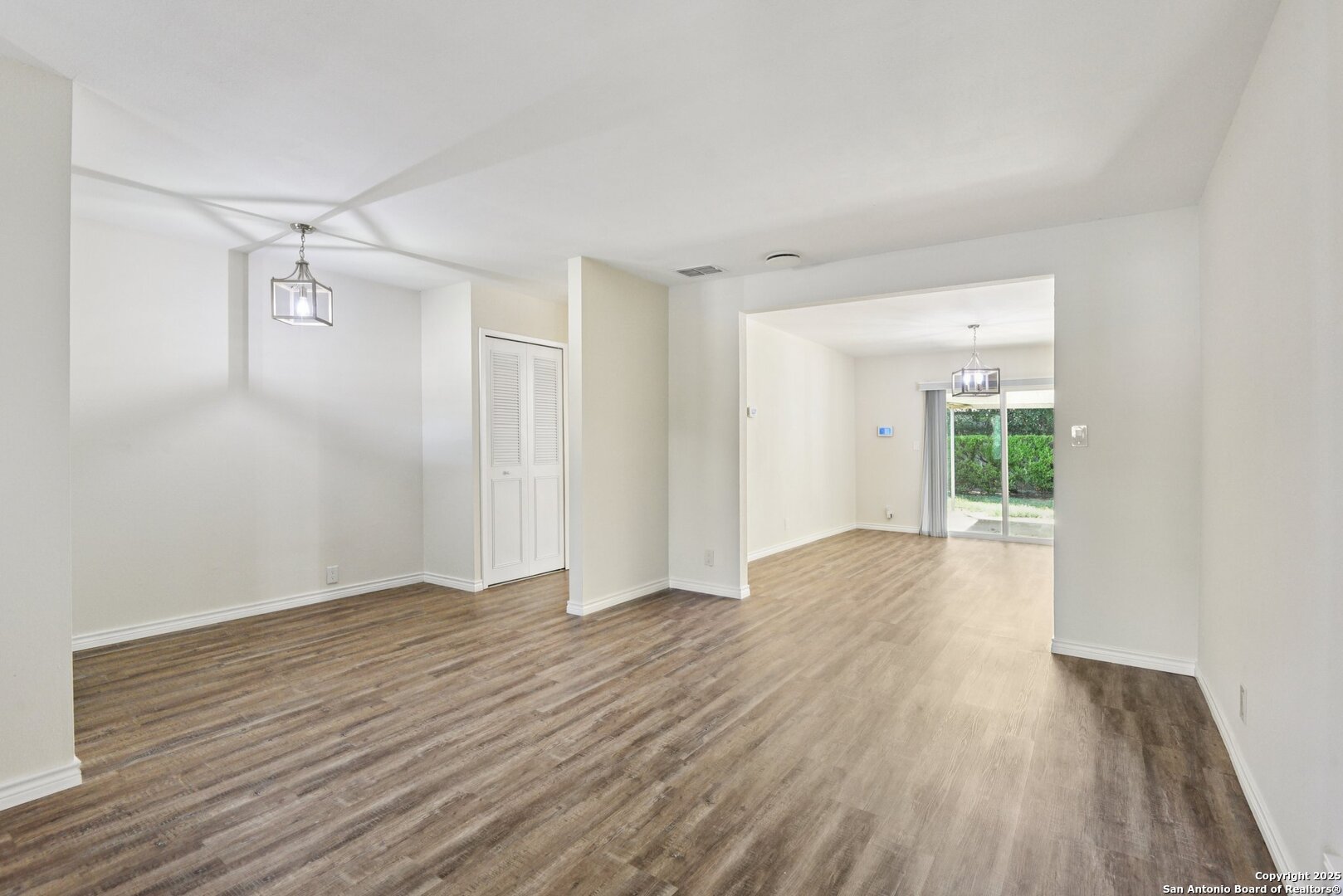 6630 Spring Hollow Street San Antonio, TX 78249 - Photo 35 of 40 a view of an empty room with wooden floor and a window
