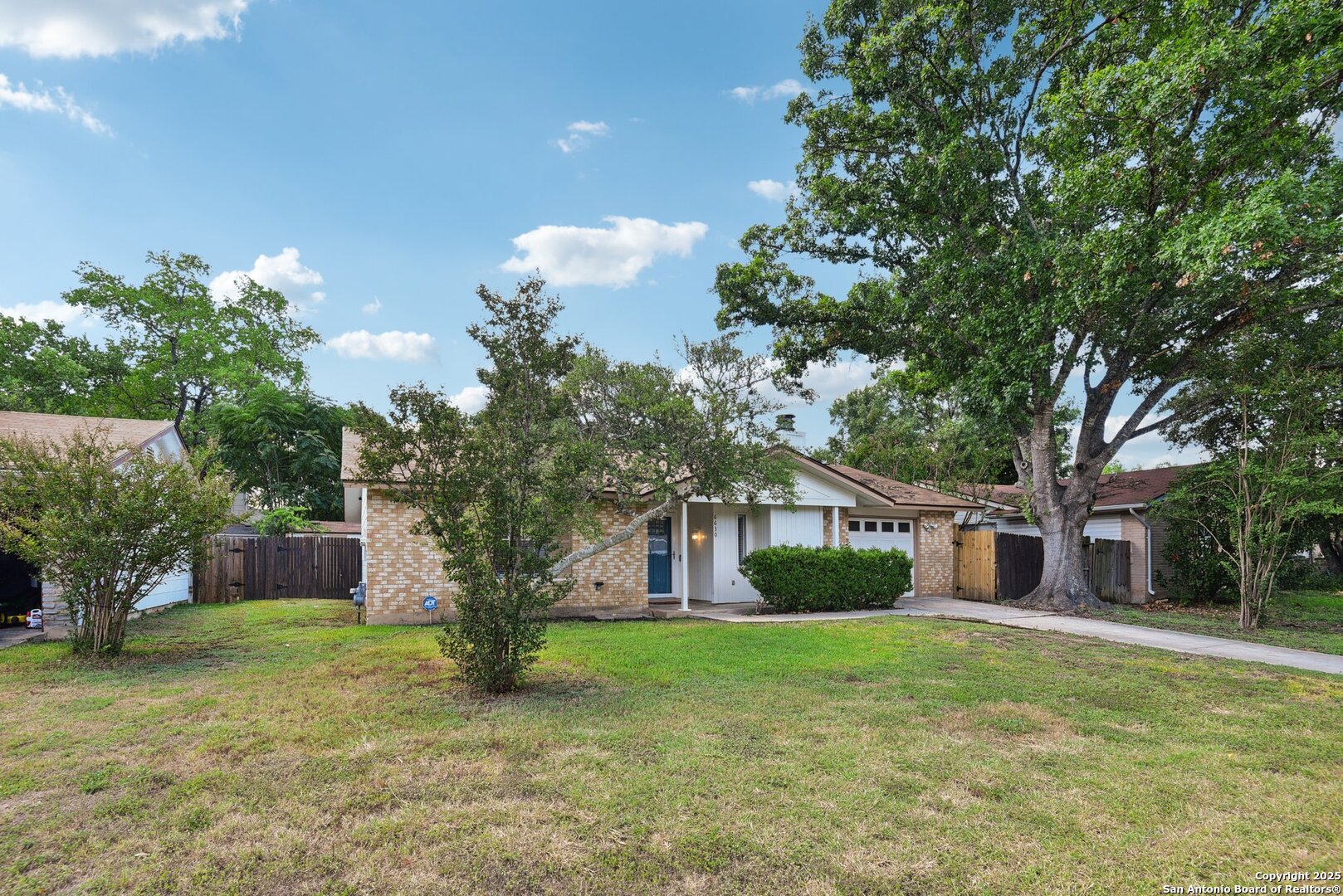 6630 Spring Hollow Street San Antonio, TX 78249 - Photo 5 of 40 a front view of a house with garden