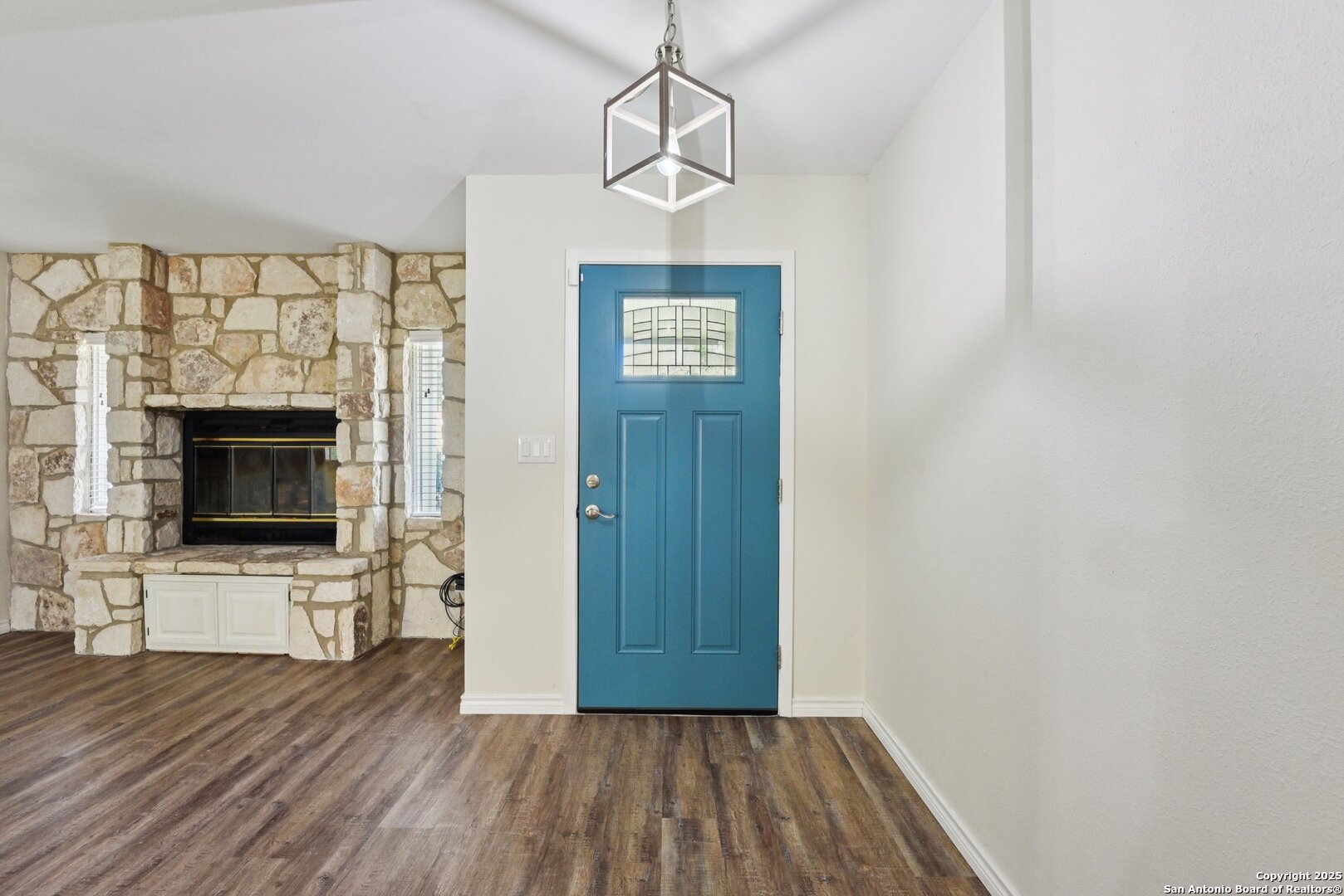 6630 Spring Hollow Street San Antonio, TX 78249 - Photo 6 of 40 a view of a livingroom with wooden floor and a fireplace