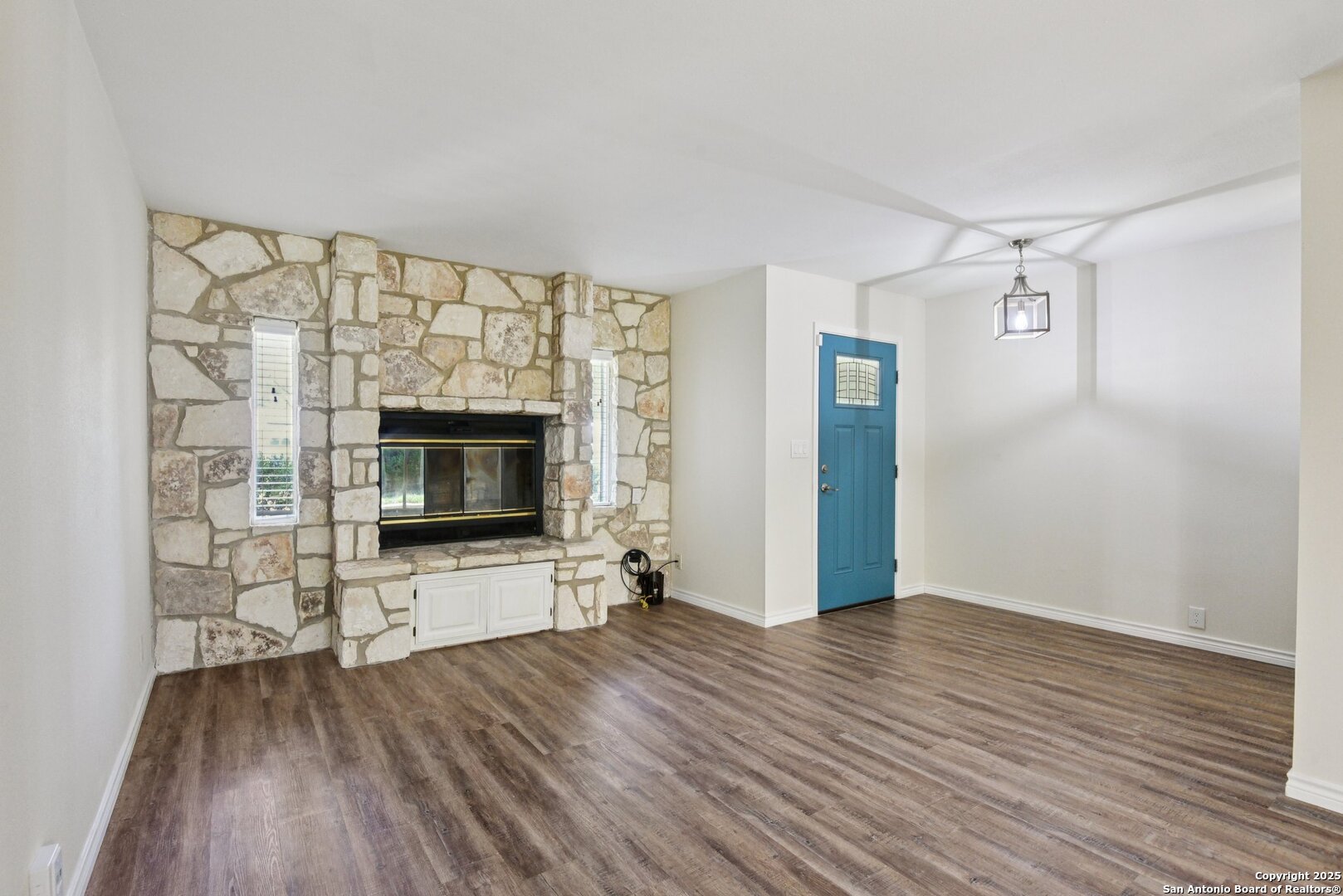 6630 Spring Hollow Street San Antonio, TX 78249 - Photo 7 of 40 a view of an empty room with wooden floor and a fireplace