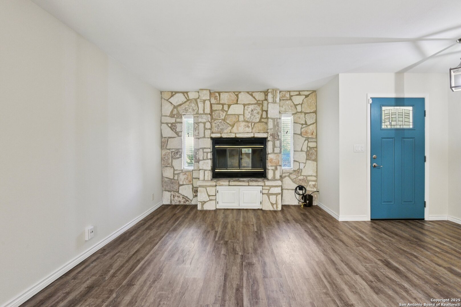 6630 Spring Hollow Street San Antonio, TX 78249 - Photo 8 of 40 a view of empty room with wooden floor and fireplace