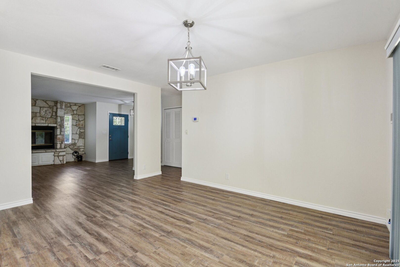 6630 Spring Hollow Street San Antonio, TX 78249 - Photo 9 of 40 a view of a room with wooden floor chandelier and windows