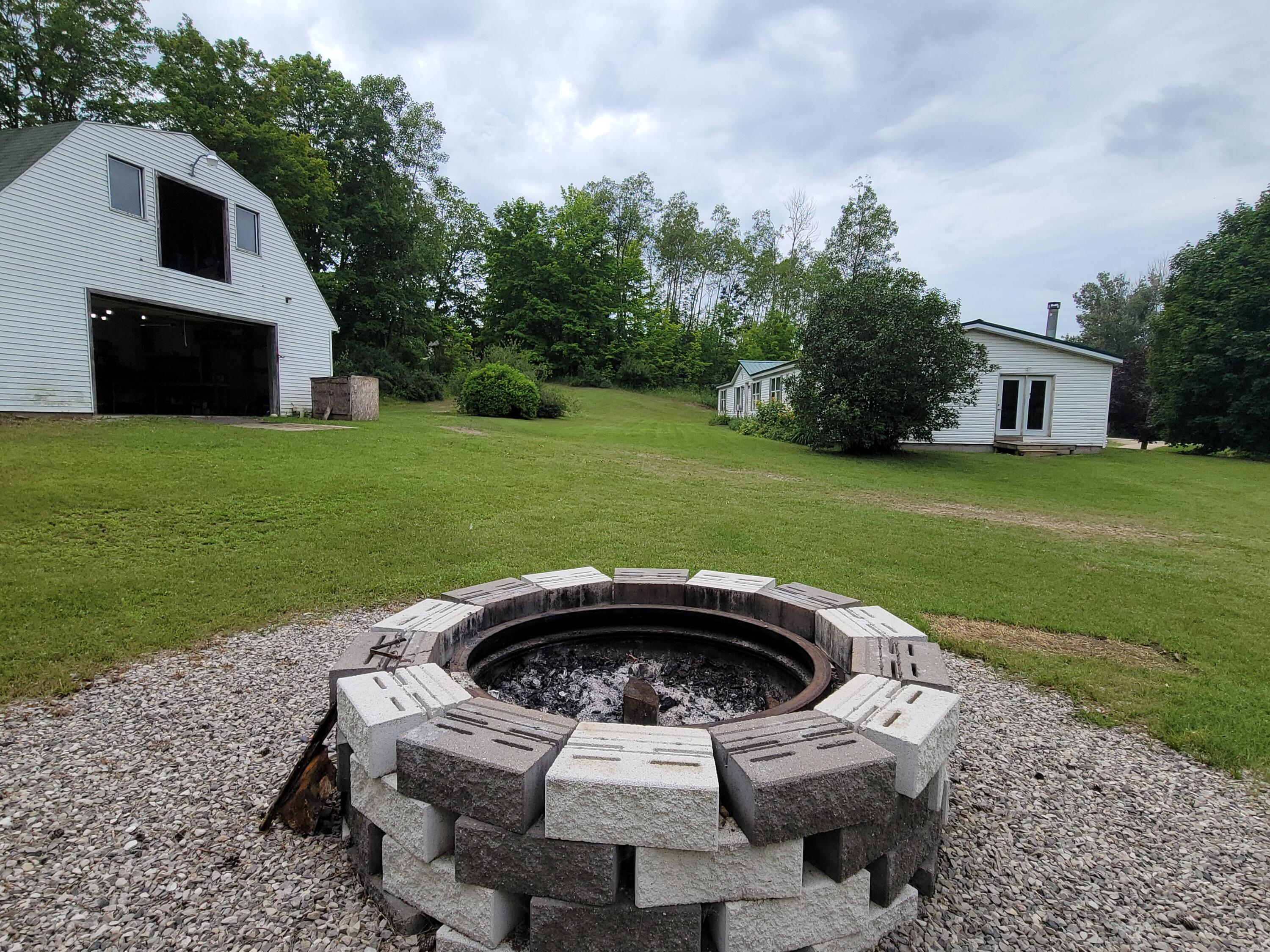 6414 West 18 Road Mesick, MI 49668 - Photo 35 of 53 Firepit near polebarn