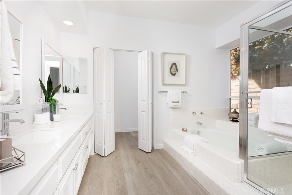 29672 Teracina Laguna Niguel, CA 92677 - Photo 13 of 35 a bathroom with a bathtub sink and mirror