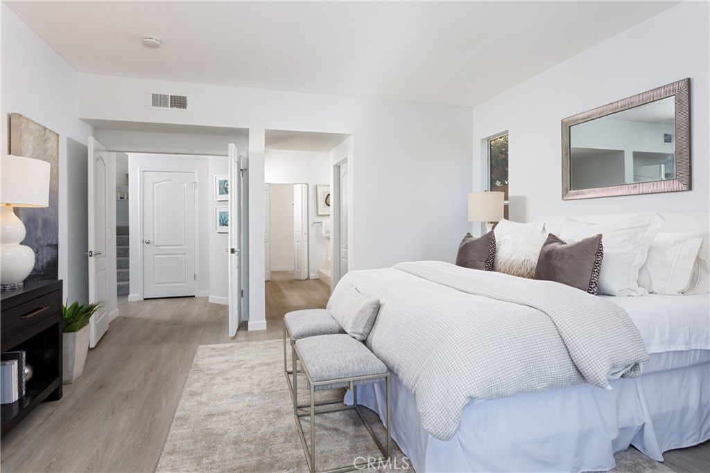 29672 Teracina Laguna Niguel, CA 92677 - Photo 18 of 35 a spacious bedroom with a bed a couch and a view of en suite bathroom