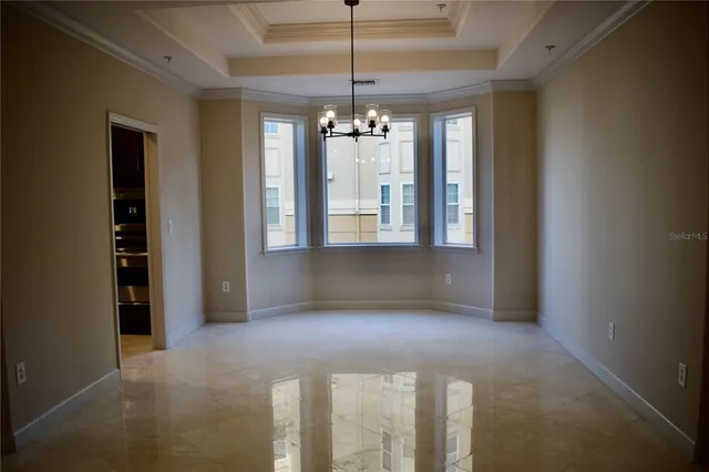 a view of a livingroom with a ceiling fan and window