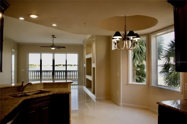 a kitchen with stainless steel appliances granite countertop a sink and a refrigerator