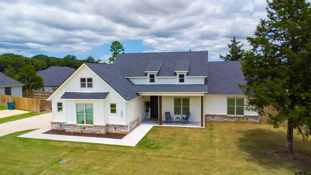 a front view of a house with a yard table and chairs