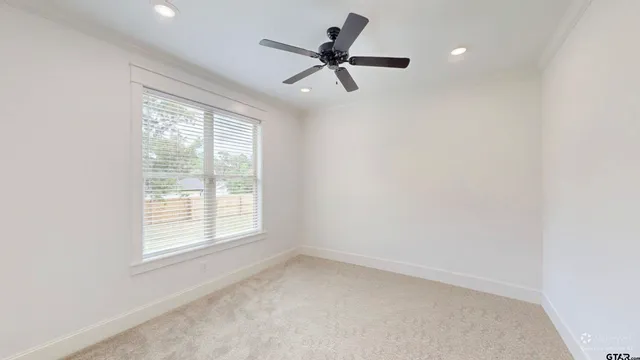 a view of empty room with ceiling fan