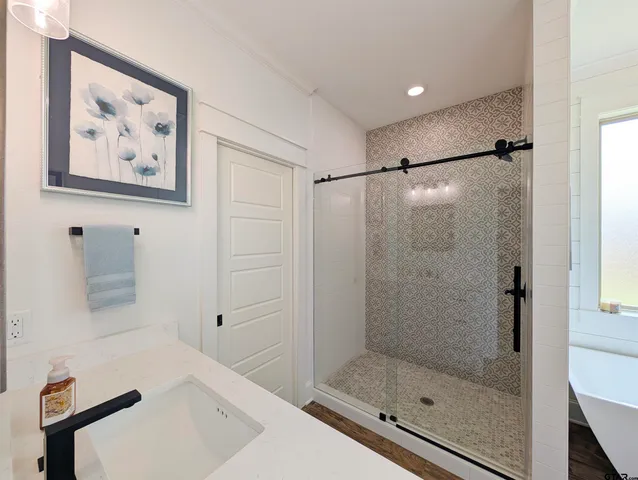 a bathroom with a bathtub and a shower