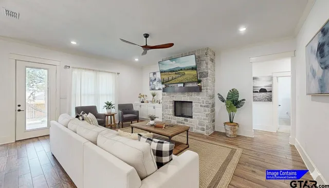 a living room with furniture fireplace and wooden floor