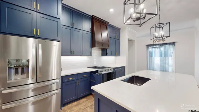 a kitchen with stainless steel appliances a refrigerator and a stove