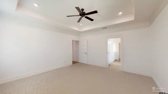 wooden floor in an empty room and a ceiling fan