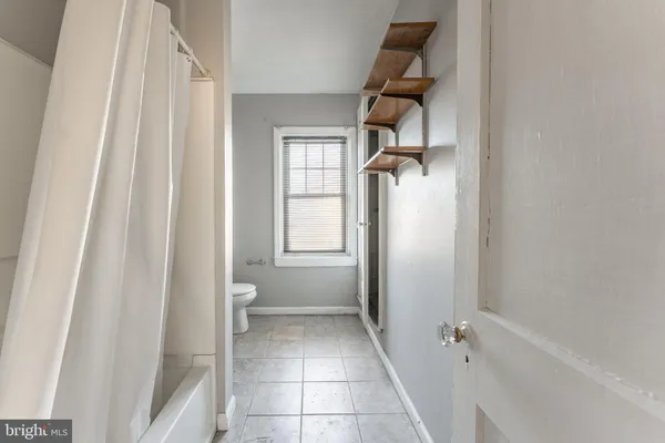 a view of bathroom with a shower and a toilet