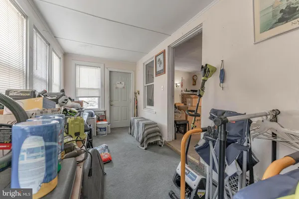 a view of a livingroom with furniture and gym equipment