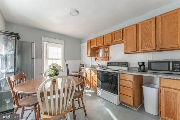 a kitchen with stainless steel appliances granite countertop a stove a sink dishwasher and cabinets with wooden floor