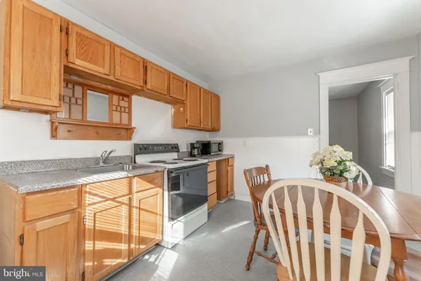 a kitchen with granite countertop stainless steel appliances a sink and cabinets