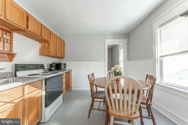 a dining room with furniture a window and kitchen view