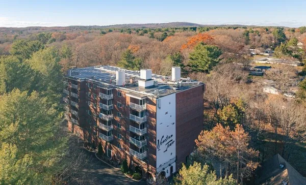 a large building with a mountain in the background
