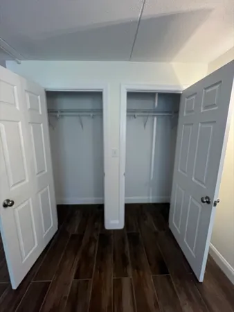 a view of a room with wooden floor