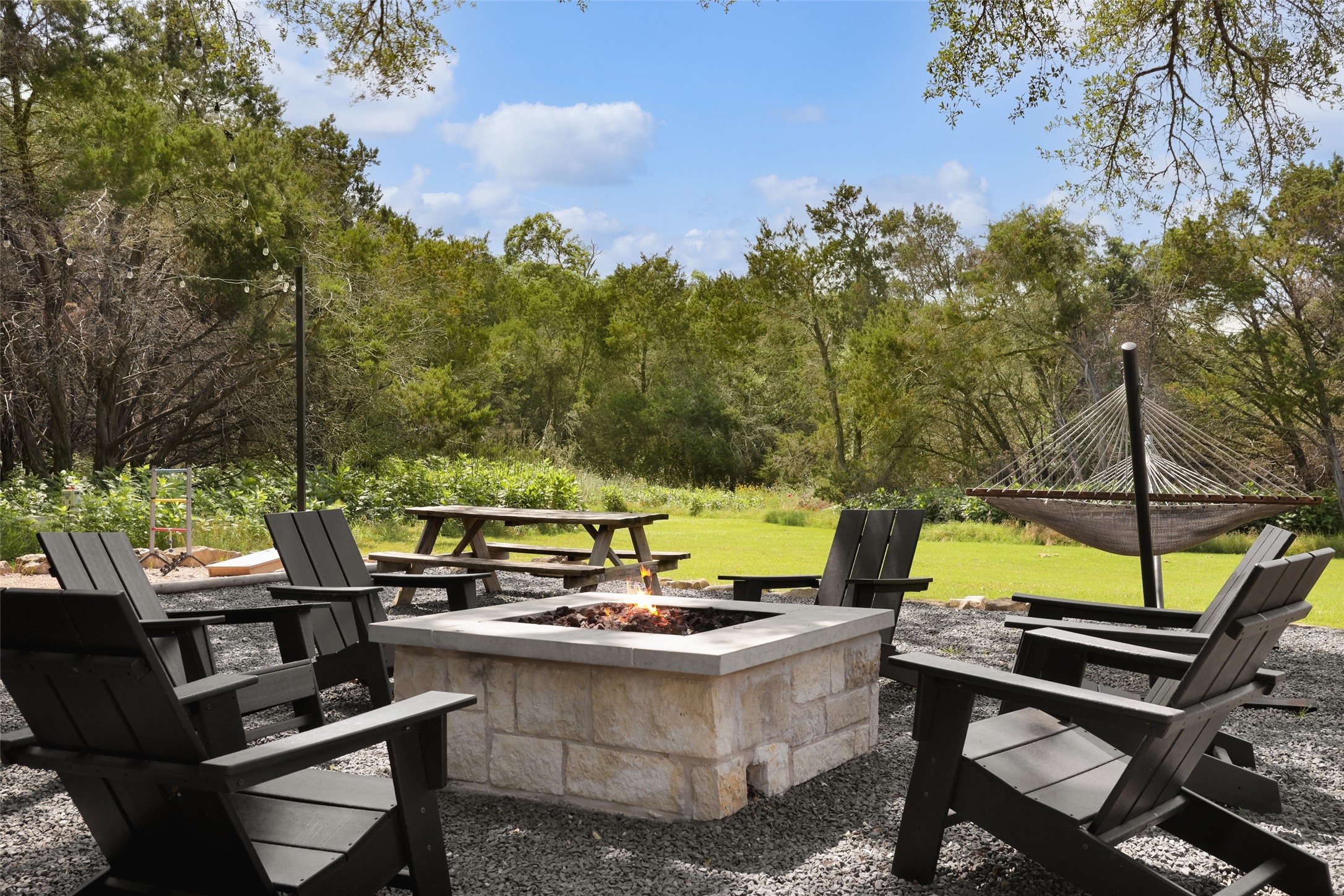 11505 Southwest Oaks Austin, TX 78737 - Photo 35 of 38 a view of a swimming pool with chairs and a fire pit