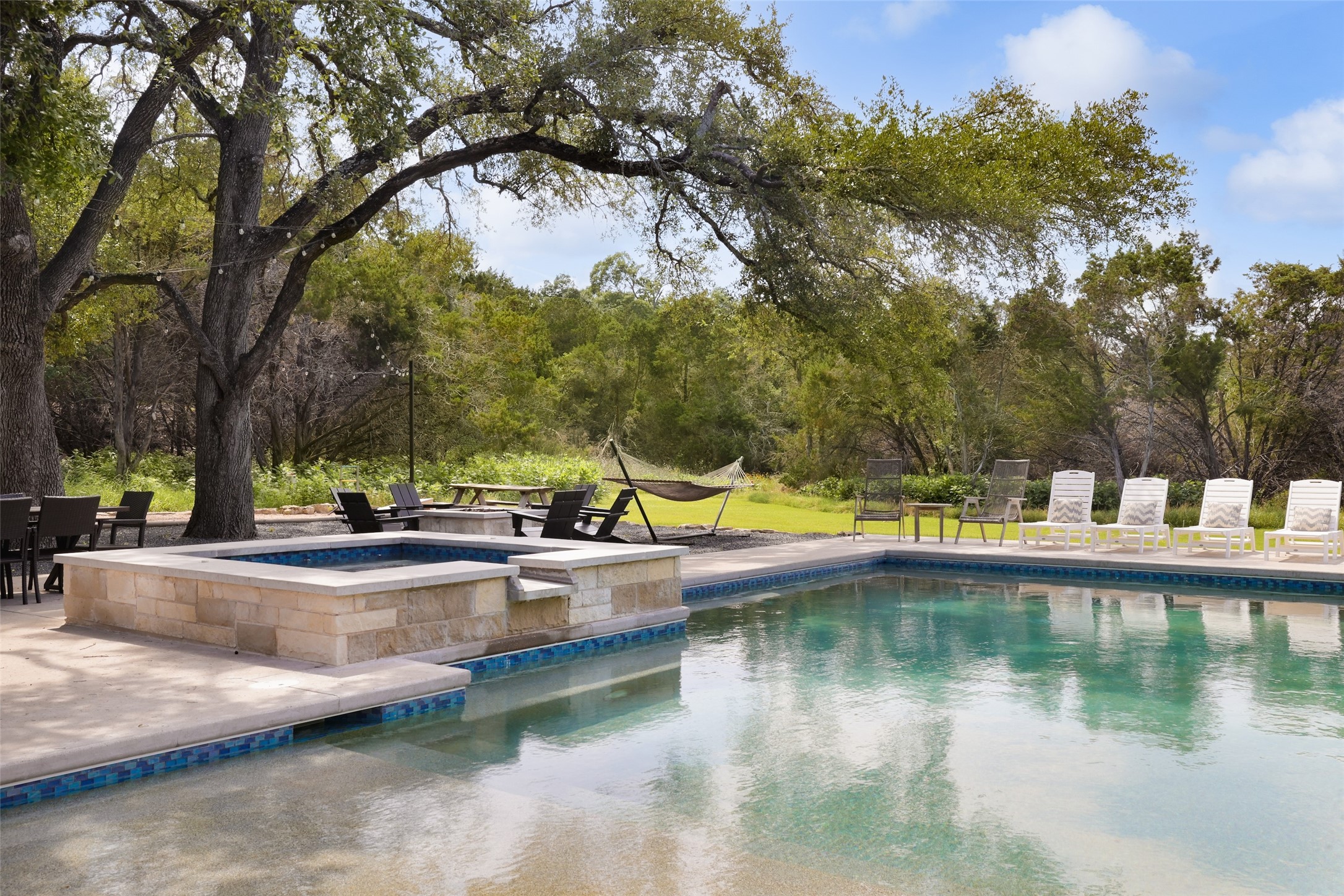 11505 Southwest Oaks Austin, TX 78737 - Photo 36 of 38 a view of swimming pool with outdoor seating and lake view