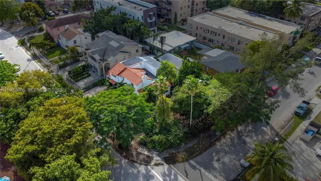 an aerial view of residential house with outdoor space and trees all around