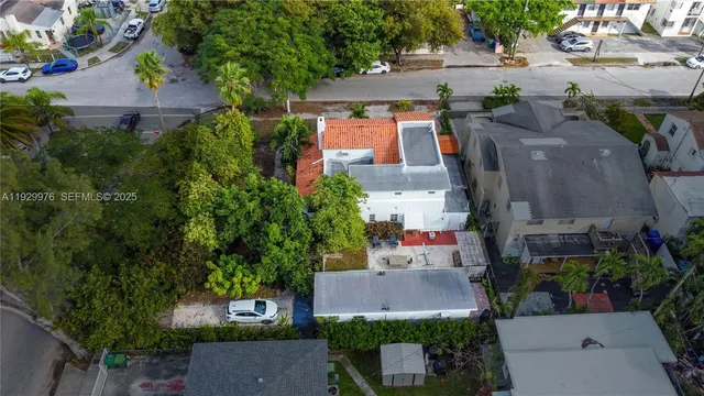 an aerial view of multiple houses with yard