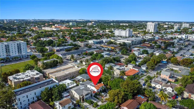 an aerial view of a house with a yard